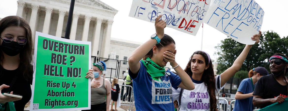 Abortion-rights activists Carrie McDonald (C) and Soraya Bata react to the Dobbs v Jackson Women's Health Organization ruling in front of the U.S. Supreme Court on June 24, 2022 in Washington, DC. The Court's decision in Dobbs v Jackson Women's Health overturns the landmark 50-year-old Roe v Wade case and erases a federal right to an abortion. (Photo by Anna Moneymaker/Getty Images)