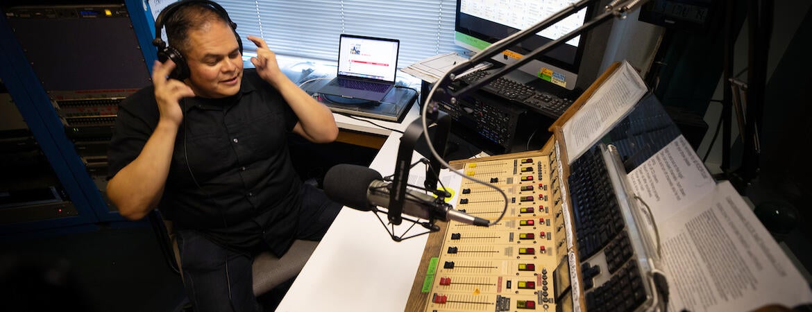 Richard T. Rodríguez, professor of English and media and cultural studies, is also a DJ on KUCR. He appears every Thursday night as "Dr. Ricky on the Radio." On Thursday, September 1, 2022, he prepared to go on the air.  (UCR/Stan Lim)