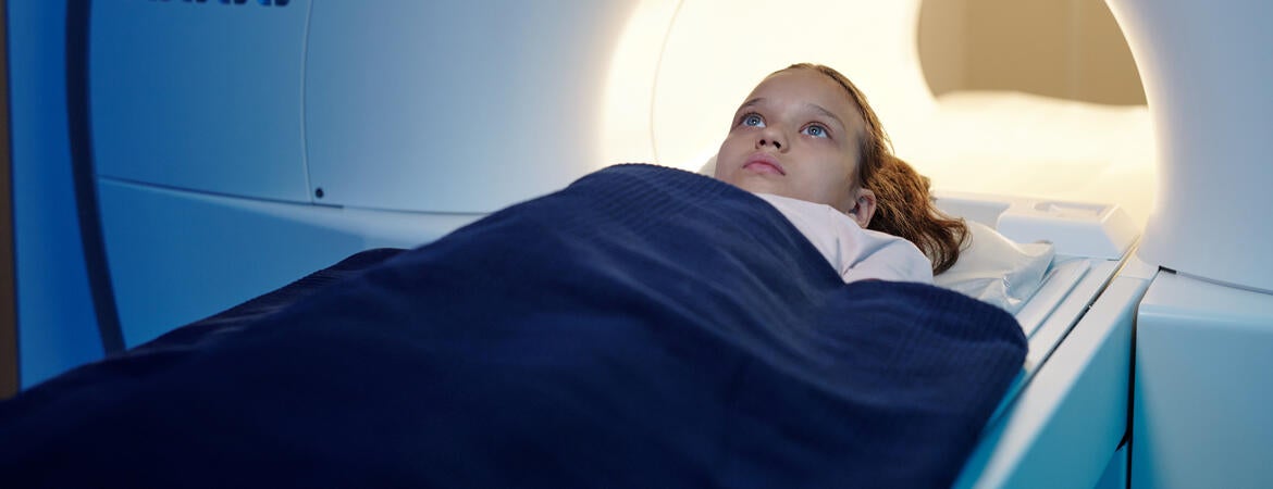 Child moving into an MRI scan machine