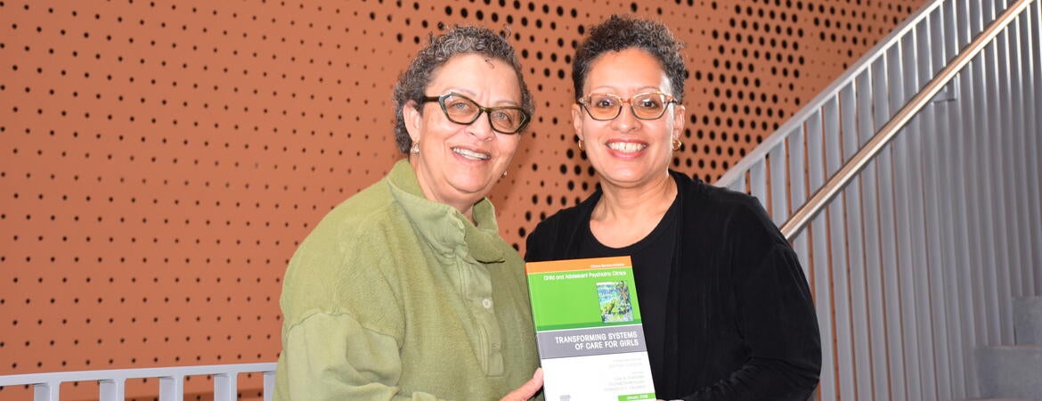 Michelle Porche and Lisa Fortuna hold a book