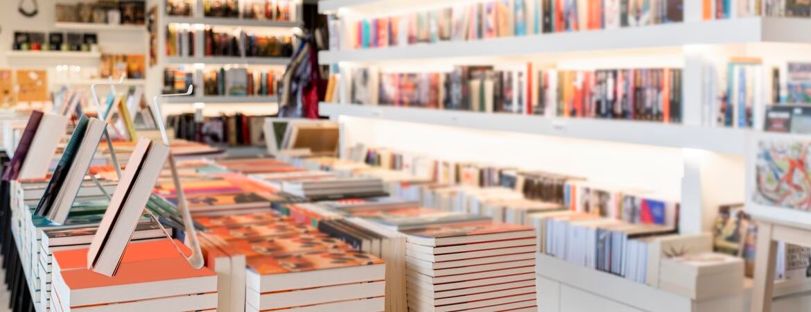 Photo of books on shelves in a bookstore.