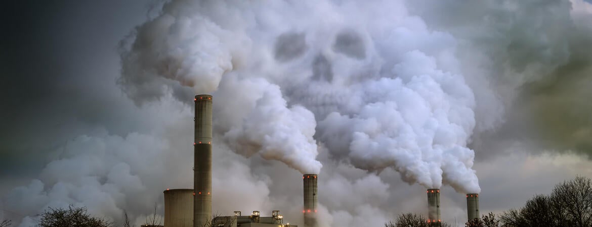 Skull visible in smoke from a factory