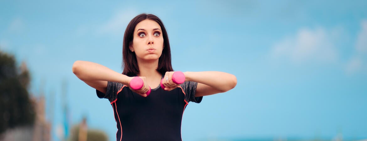 Pregnant woman holding weights