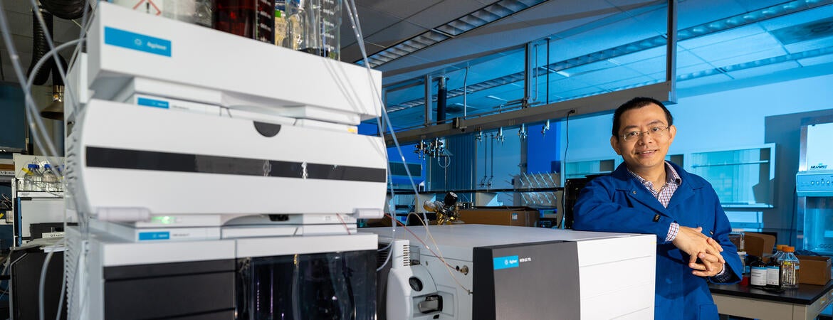 Jinyong Liu Associate Professor, Chemical Environ Engineering Dept., with a mass spectrometer he uses as part of his PFAS research