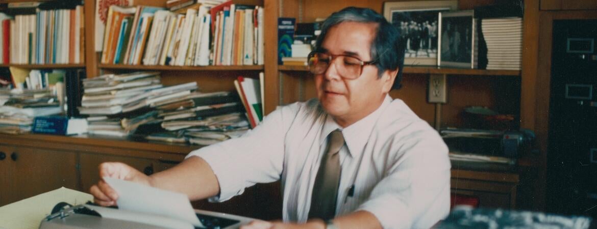 Photograph shows Tomás Rivera at his desk at UC Riverside.