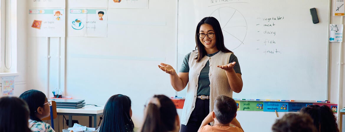 Happy teacher in classroom