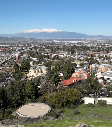 A view overlooking UC Riverside with snow-covered Mt. Baldy in the distance