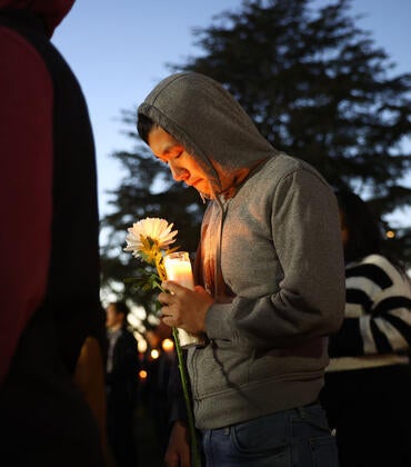 MONTEREY PARK, CALIFORNIA - JANUARY 24: People attend a candlelight vigil for victims of a deadly mass shooting at a ballroom dance studio on January 24, 2023 in Monterey Park, California. Eleven people died and nine more were injured at the studio near a Lunar New Year celebration last Saturday night. Vice President Kamala Harris is scheduled to visit the predominantly Asian American community tomorrow. (Photo by Mario Tama/Getty Images)