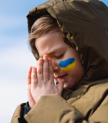 Ukrainian boy praying