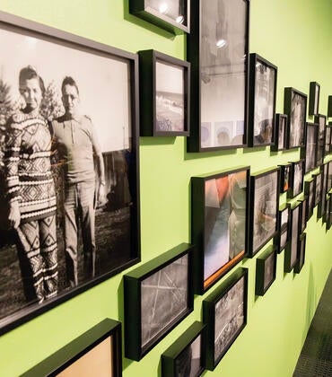 A woman views the "Shadow Archive" exhibition at UCR ARTS