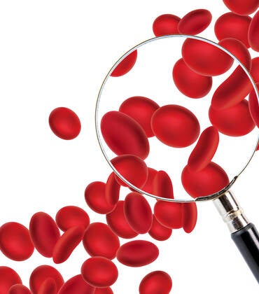 Red blood cells and a magnifying glass