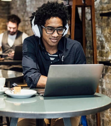 Man using a laptop in a coffee shop