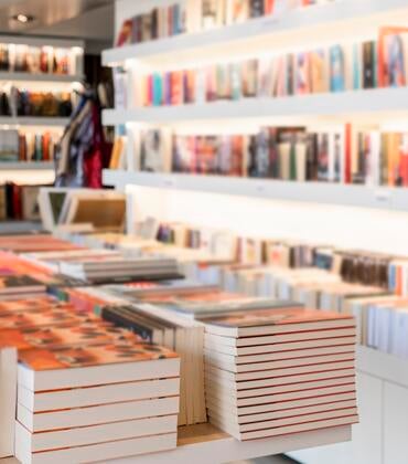Photo of books on shelves in a bookstore.