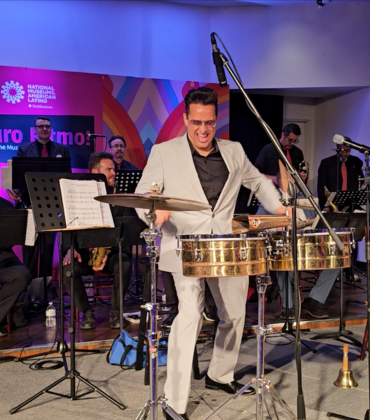 A man plays the timbales with the Mambo Legends Orchestra.