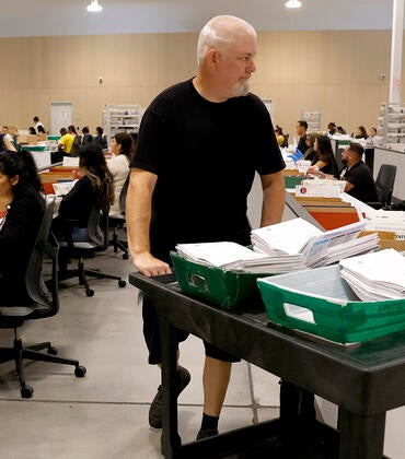 Election workers process ballots for the California state primary election at the Los Angeles County Ballot Processing Center on June 05, 2026 in City of Industry, California.