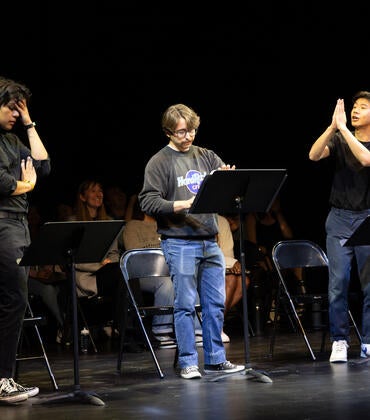 Students performing a stage reading