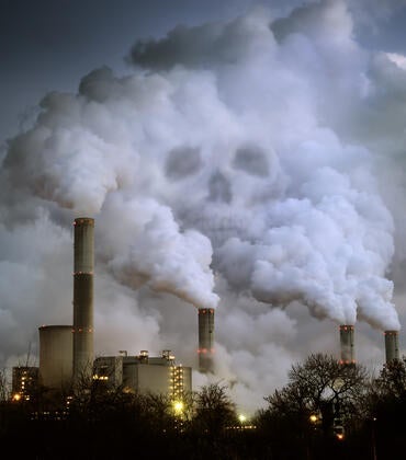Skull visible in smoke from a factory