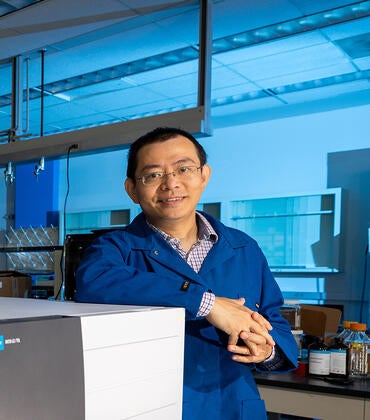 Jinyong Liu Associate Professor, Chemical Environ Engineering Dept., with a mass spectrometer he uses as part of his PFAS research