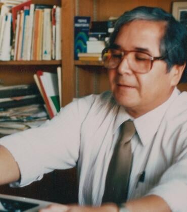 Photograph shows Tomás Rivera at his desk at UC Riverside.