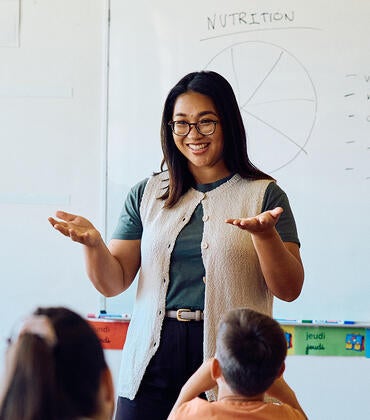 Happy teacher in classroom