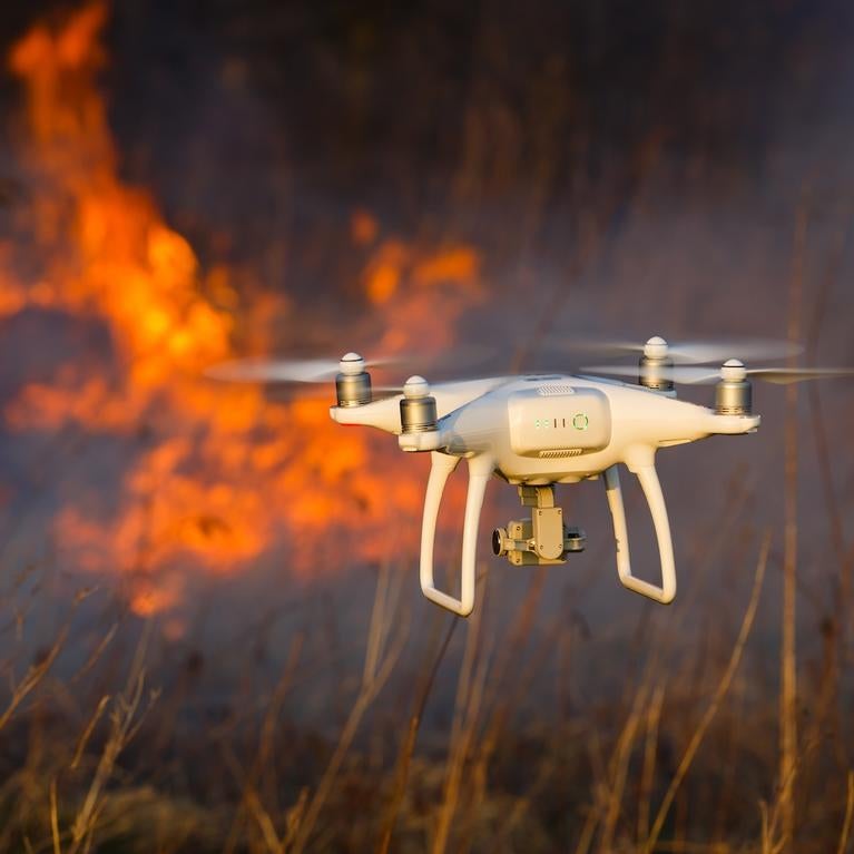 A drone hovers near a wildfire