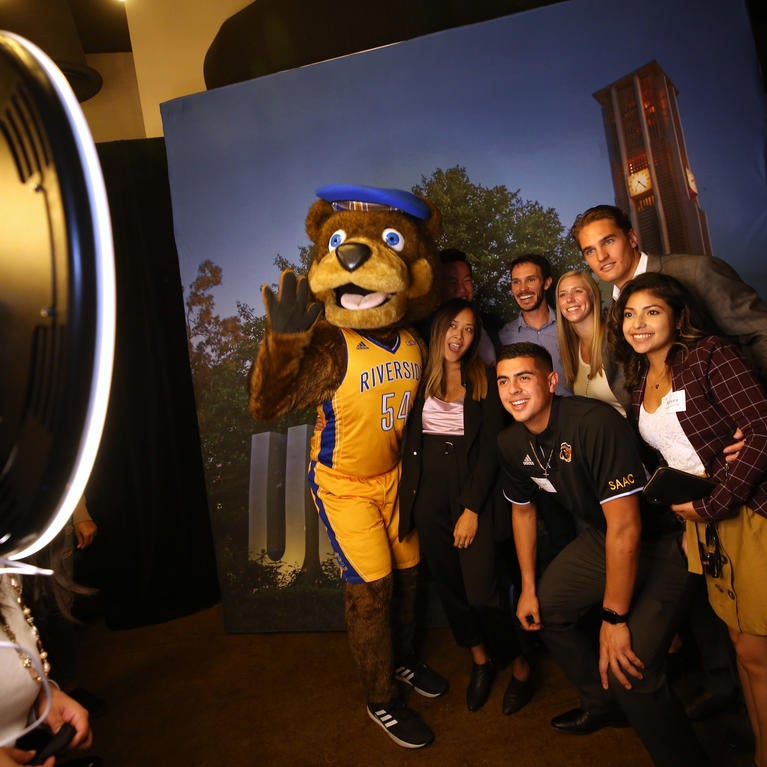 Alumni with Scotty the Bear