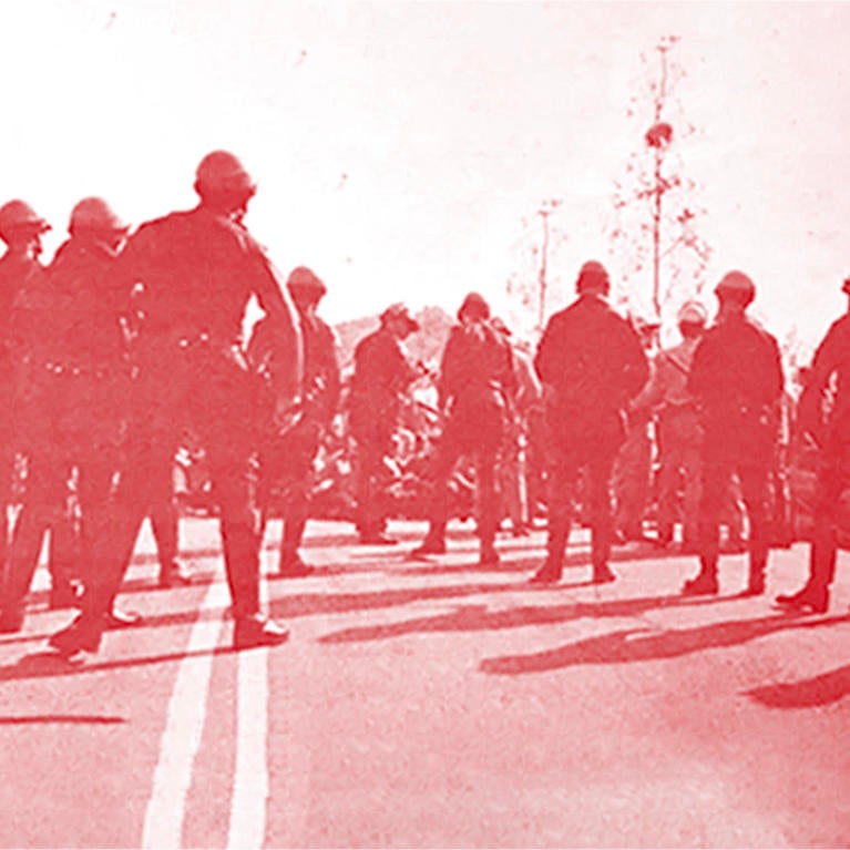 The police officers formed a “V” formation to clear the roadway by Fawcett.