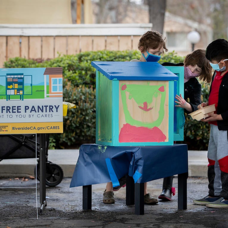 Children painting the Free Little Pantry on Thursday, March 11, 2021, at the Oban Family Housing. (UCR/Stan Lim) 