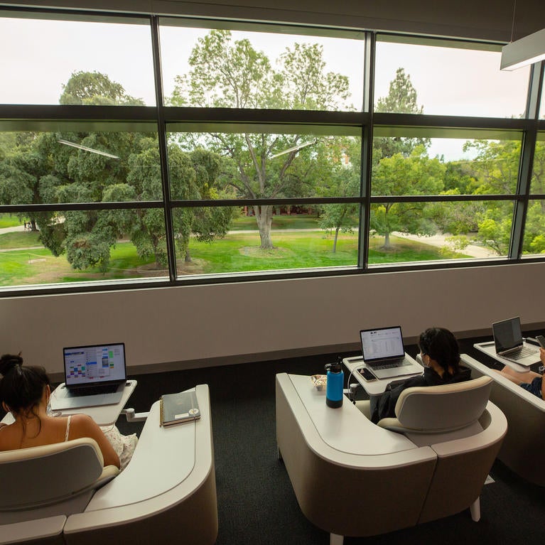 Students studying at UCR Student Success Center's study cubbies.