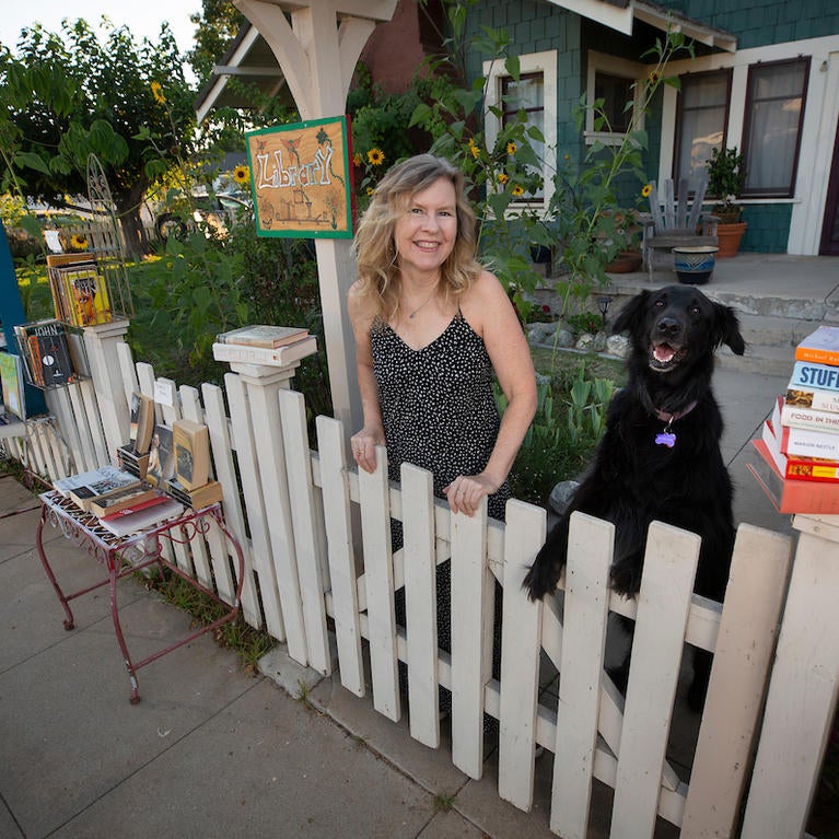 UCR Distinguished Professor Susan Straight in her front yard with her dog Angel on July 27, 2020, in Riverside. (UCR/Stan Lim)