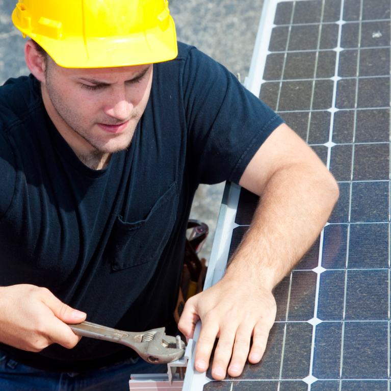 A man installs a solar panel