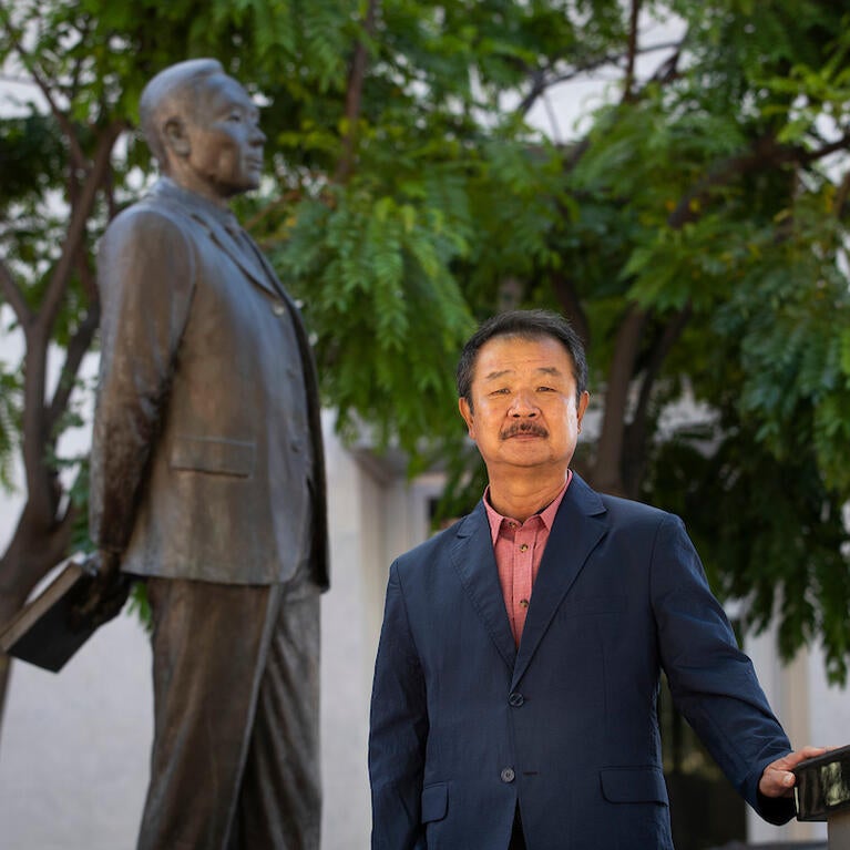Edward T. Chang, professor of ethnic studies and founding director of the Young Oak Kim Center for Korean American Studies at UC Riverside. He stands in front of the statue of Korean independence activists, Dosan Ahn Chang Ho in downtown Riverside on May 26, 2021. (UCR/Stan Lim)