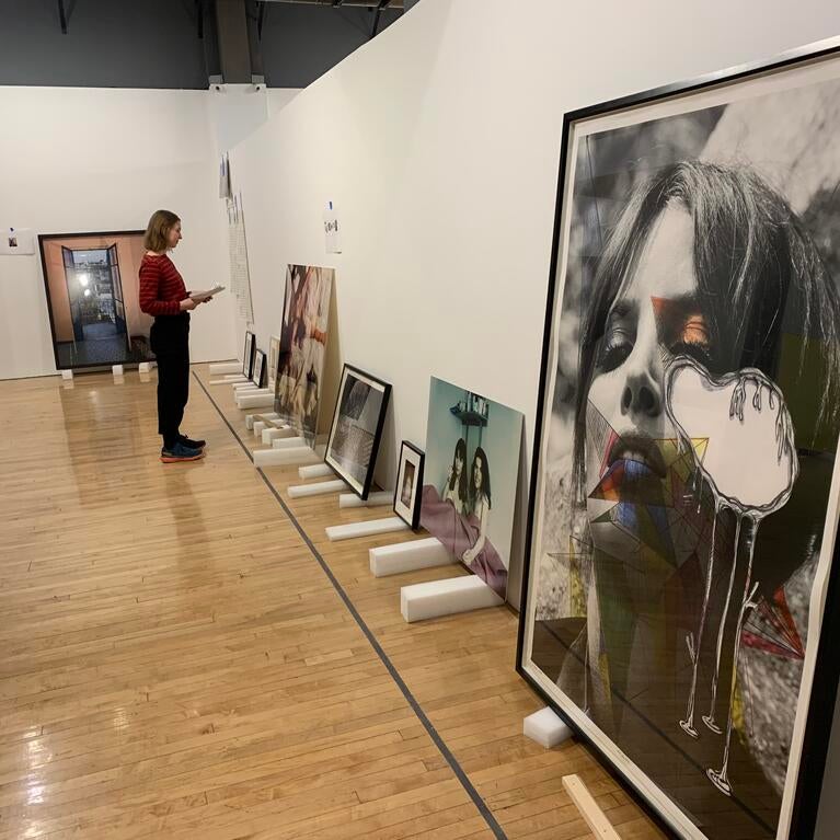 Kathryn Poindexter-Akers looks at the wall layout at the California Museum of Photography on March 7, 2023. (UCR/Sandra Baltazar Martínez)
