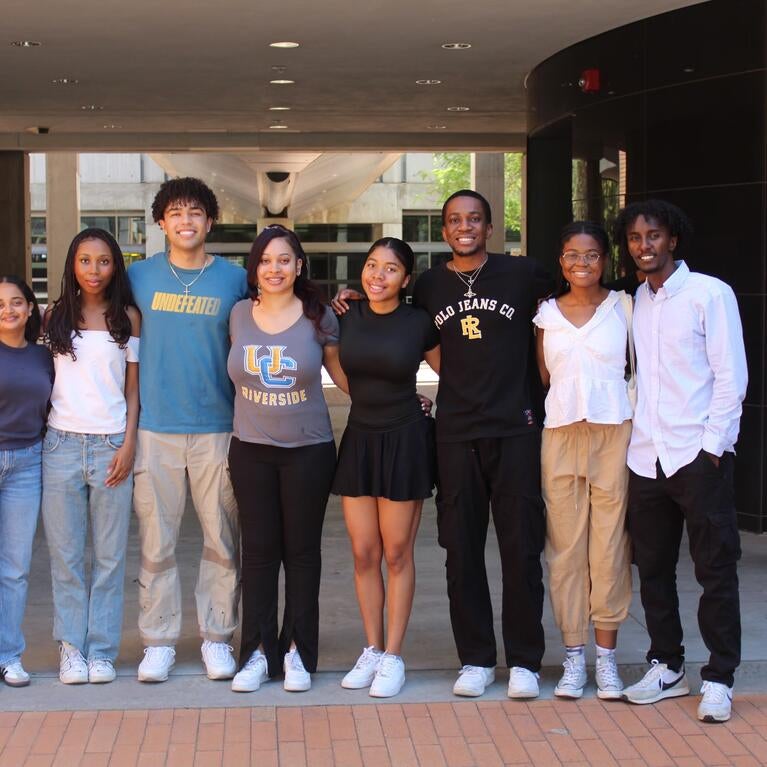 Black engineering students standing outside taking group photo