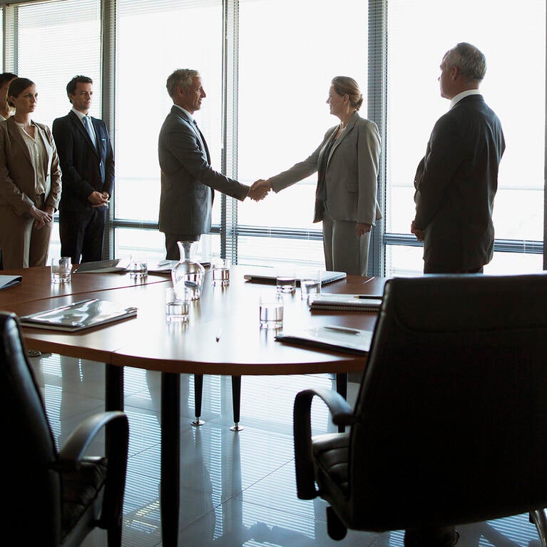 Corporate board room handshake