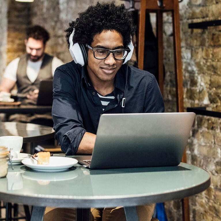 Man using a laptop in a coffee shop