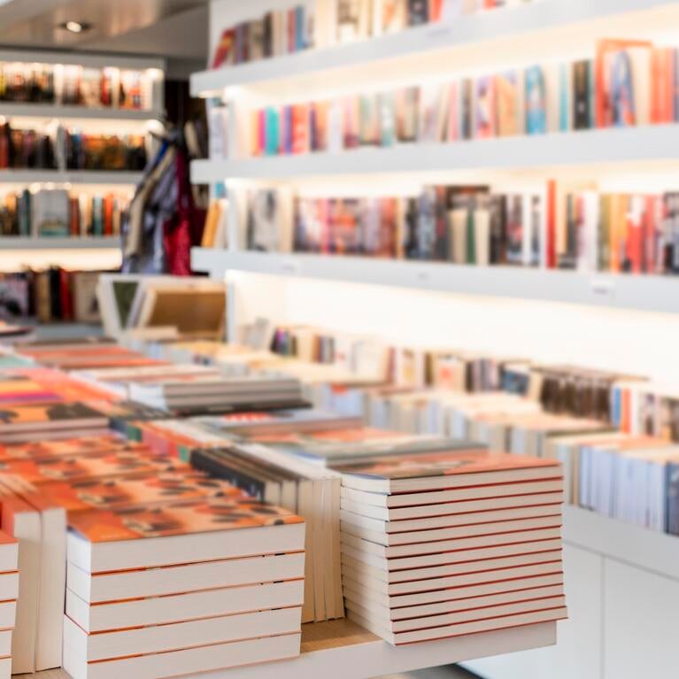 Photo of books on shelves in a bookstore.