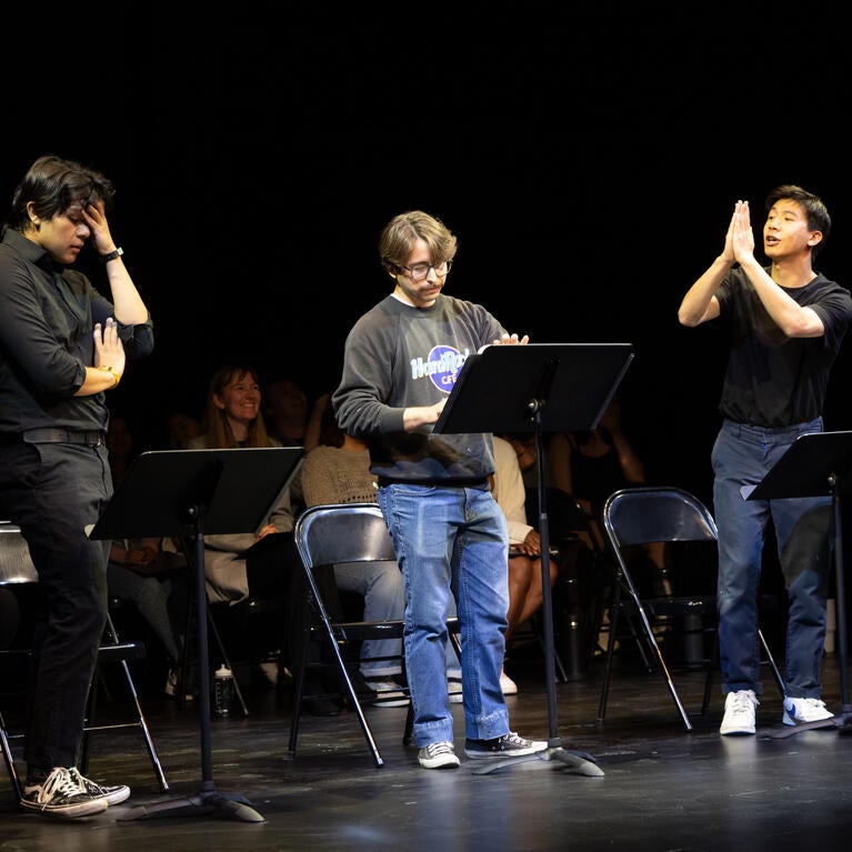 Students performing a stage reading