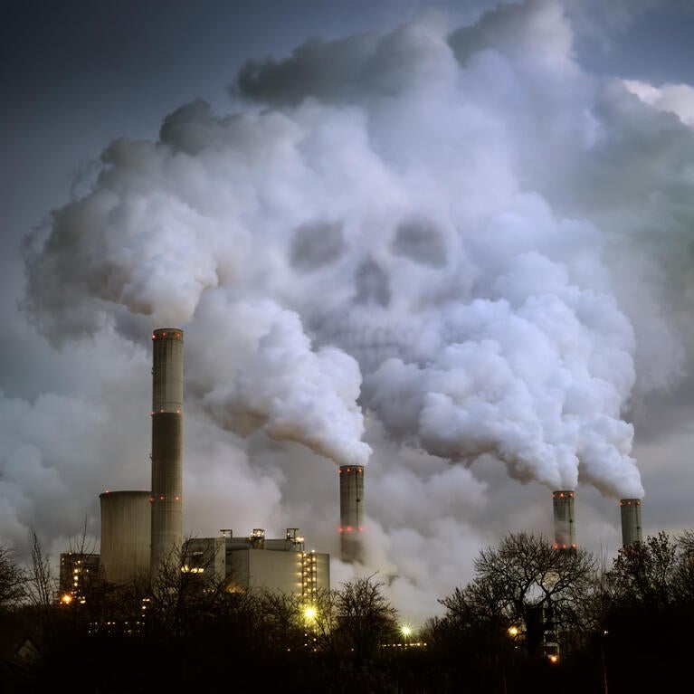 Skull visible in smoke from a factory