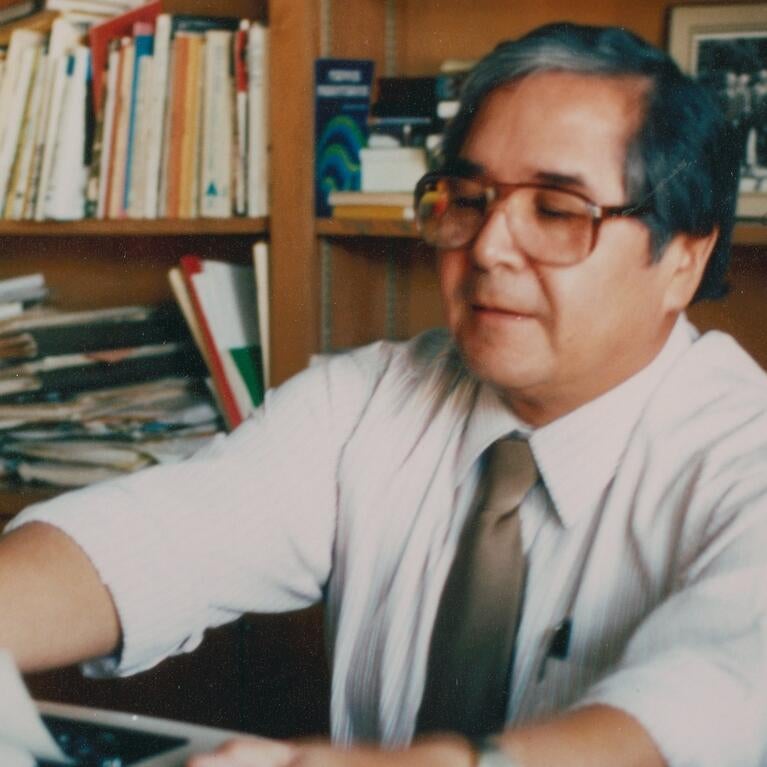 Photograph shows Tomás Rivera at his desk at UC Riverside.