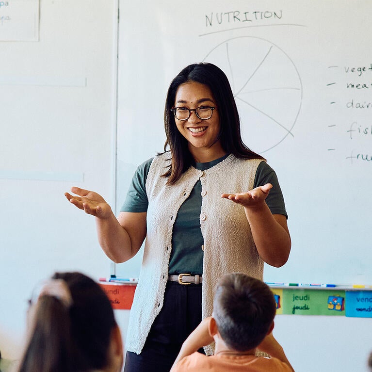 Happy teacher in classroom