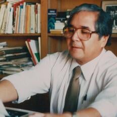 Photograph shows Tomás Rivera at his desk at UC Riverside.