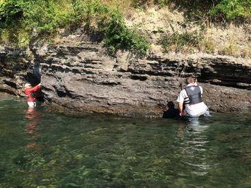 A photo of UCR’s Alex Zumberge and a colleague collecting 750 million-year-old rocks from a lake outcrop in Sweden. 
