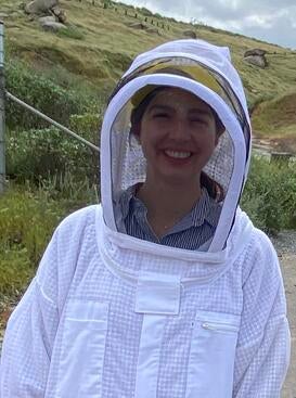 Ysabel Giraldo in a beekeeping suit