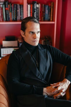 Brandon Andrew Robinson sits in a chair. 