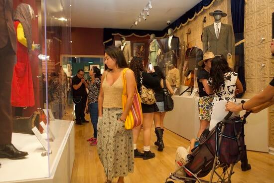 Photo of a woman gazing at a display case at the exhibition.