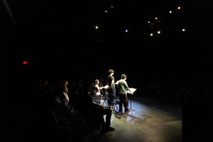 Students performing a stage reading