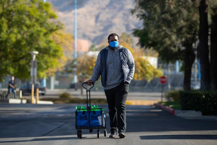 Kenyon Lee Whitman, Office of Foster Youth Support Services program director, continues his morning delivering gifts to Guardian Scholars on Monday, December 14, 2020 at UC Riverside. (UCR/Stan Lim)