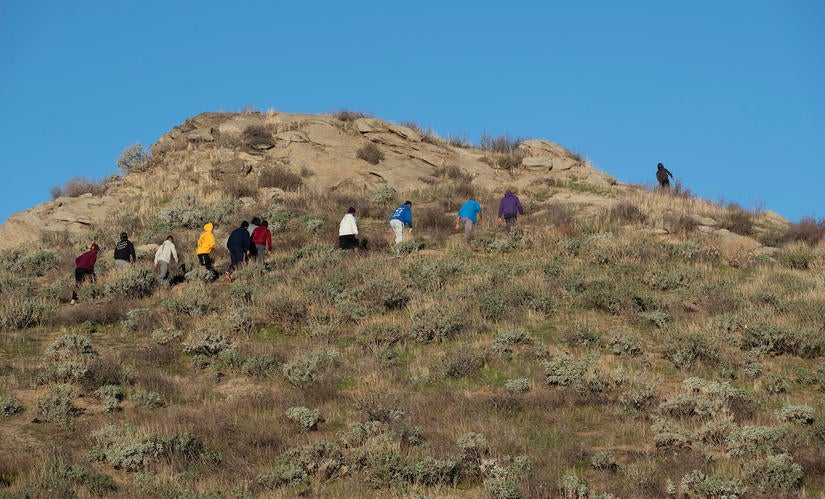 Barbershop Walk participants head up a hill near parking lot 9 on Friday, February 5, 2021. (UCR/Stan Lim)