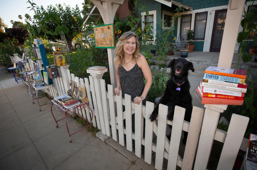 UCR Distinguished Professor Susan Straight in her front yard with her dog Angel on July 27, 2020, in Riverside. (UCR/Stan Lim)